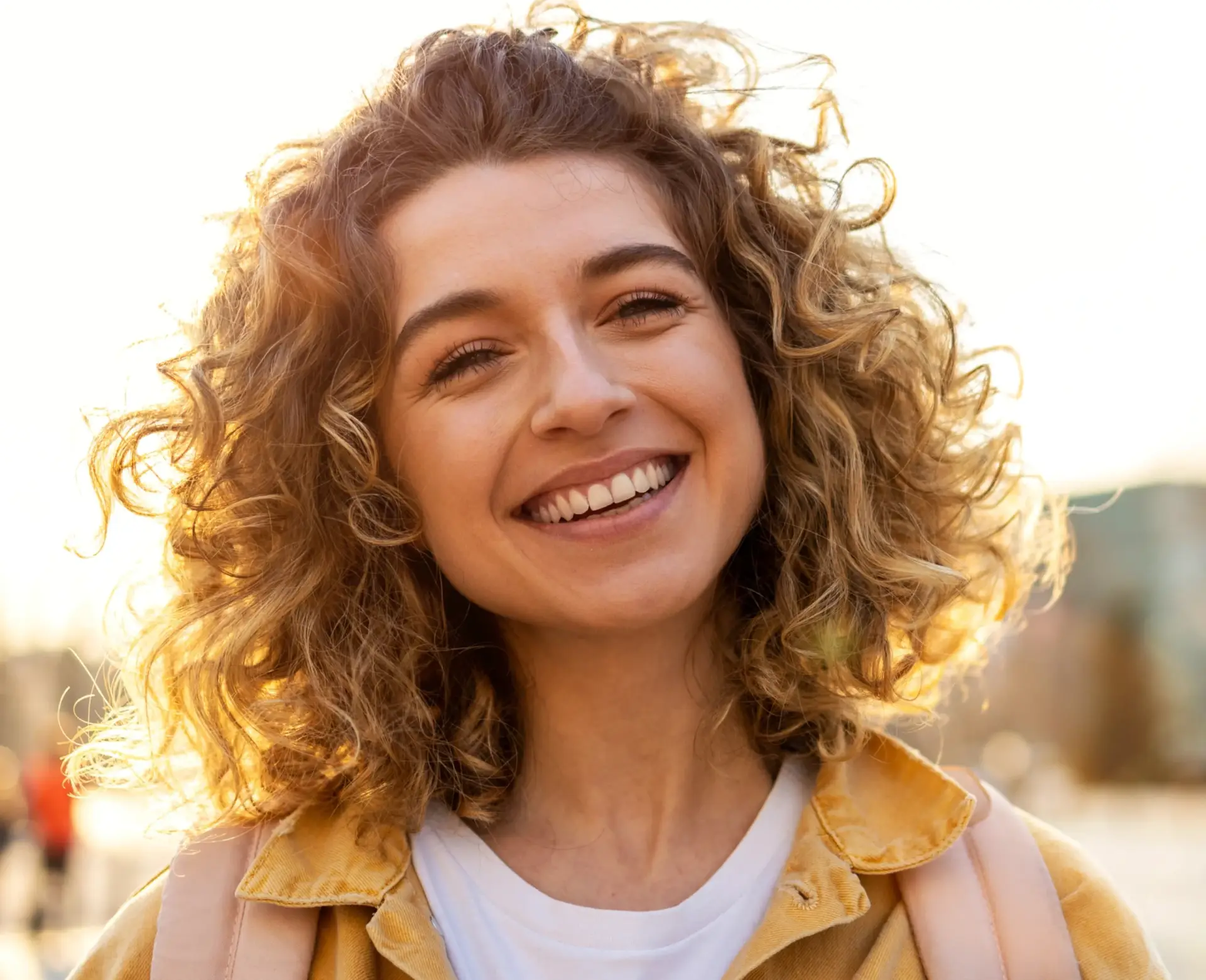 A satisfied customer smiling while standing beside a newly installed CCTV camera on their home, showcasing professional service and trust in Remote CCTV UK's security solutions