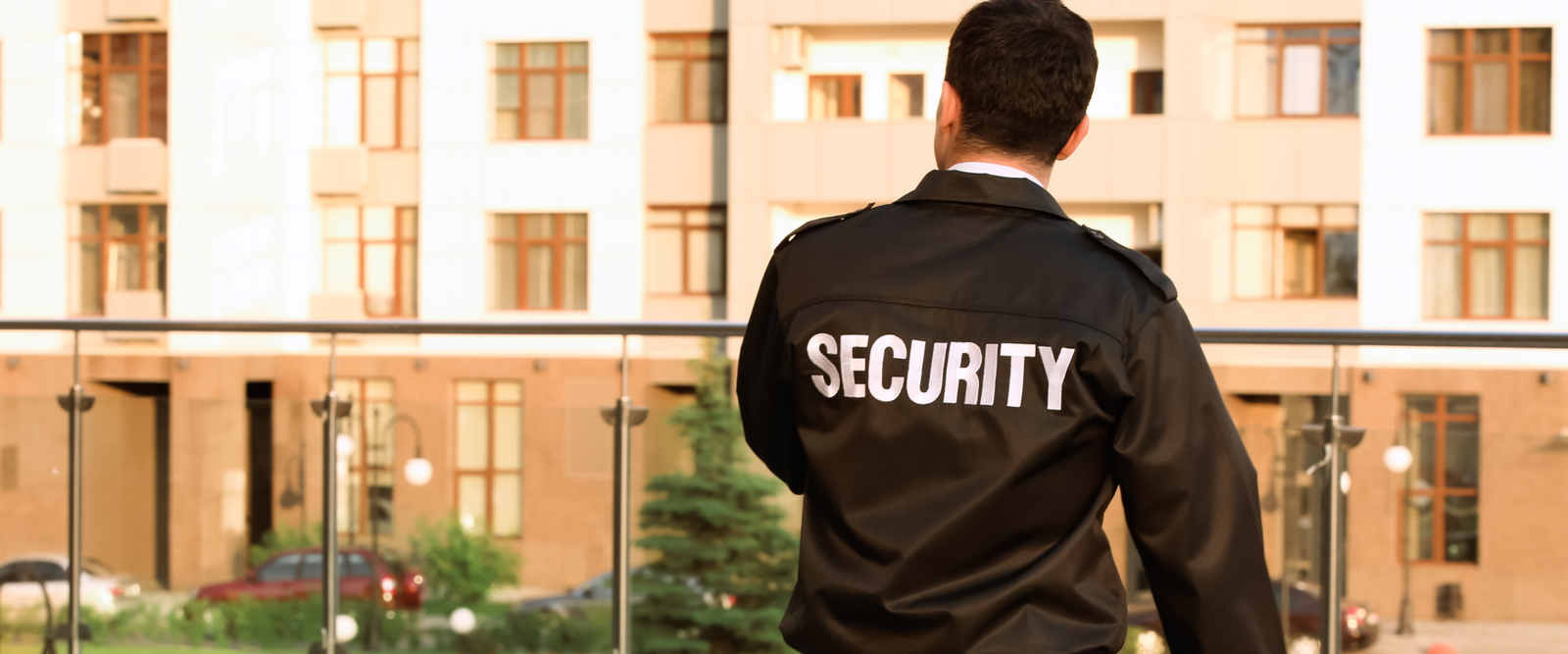 Professional London security guard in SIA-licensed uniform providing security services outside UK commercial building